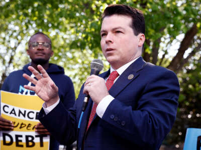 Rep. Brendan Boyle speaks to supporters at an outdoor event
