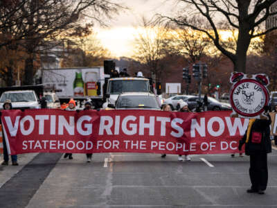 Activists rally for voting rights and DC statehood as they block traffic on Pennsylvania Avenue SE on December 7, 2021, in Washington, D.C.