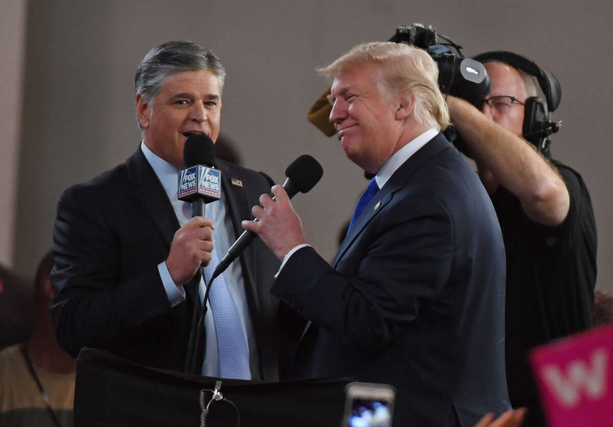 Fox News Channel and radio talk show host Sean Hannity, left, interviews then-President Donald Trump before a campaign rally at the Las Vegas Convention Center on September 20, 2018, in Las Vegas, Nevada.