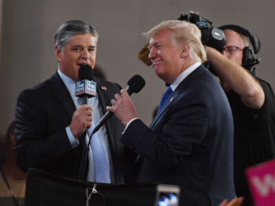 Fox News Channel and radio talk show host Sean Hannity, left, interviews then-President Donald Trump before a campaign rally at the Las Vegas Convention Center on September 20, 2018, in Las Vegas, Nevada.