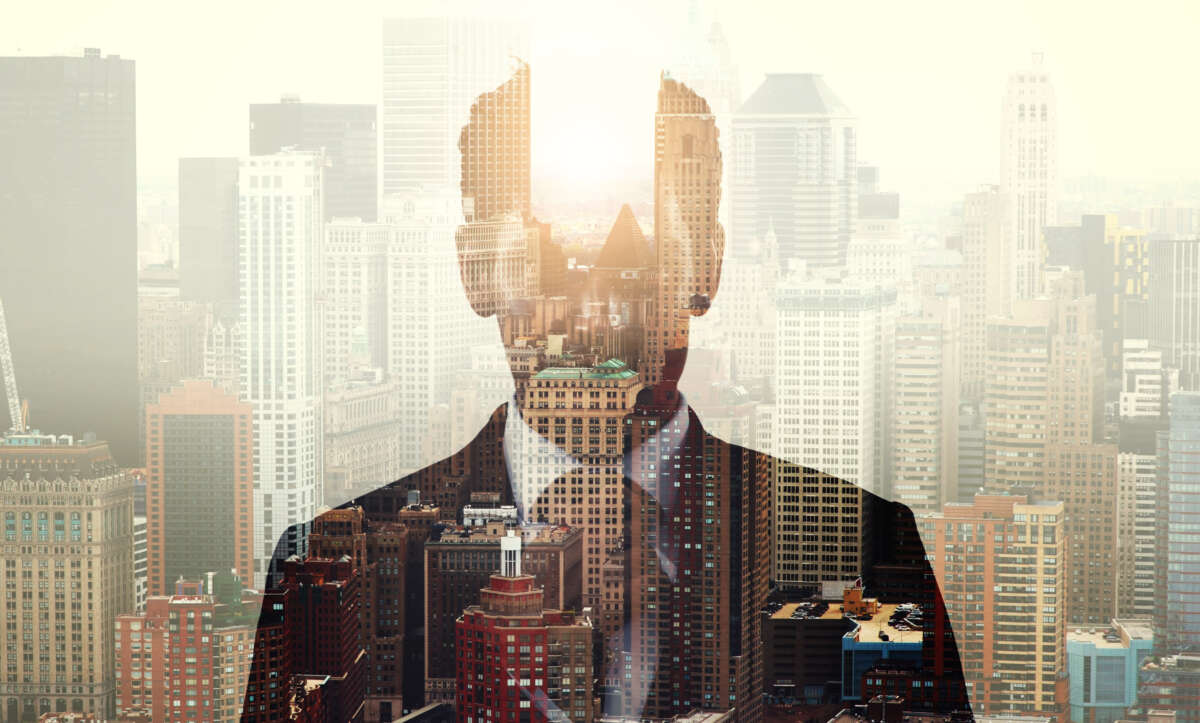 Businessman image overlaid on city, with gap in building suggesting gap in CEO's head.
