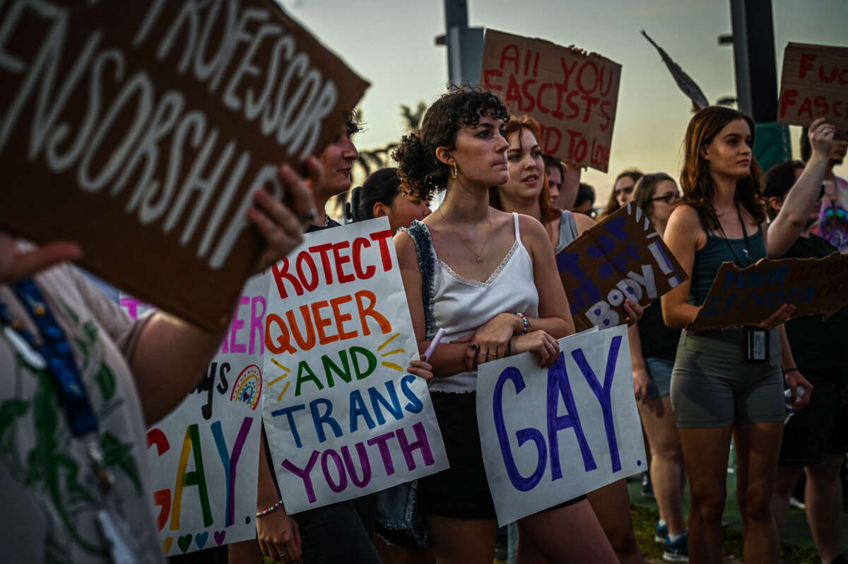 LGBTQ rights supporters protest against Florida Gov. Ron Desantis outside a campaign event at the Alico Arena on November 6, 2022, in Fort Myers, Florida.