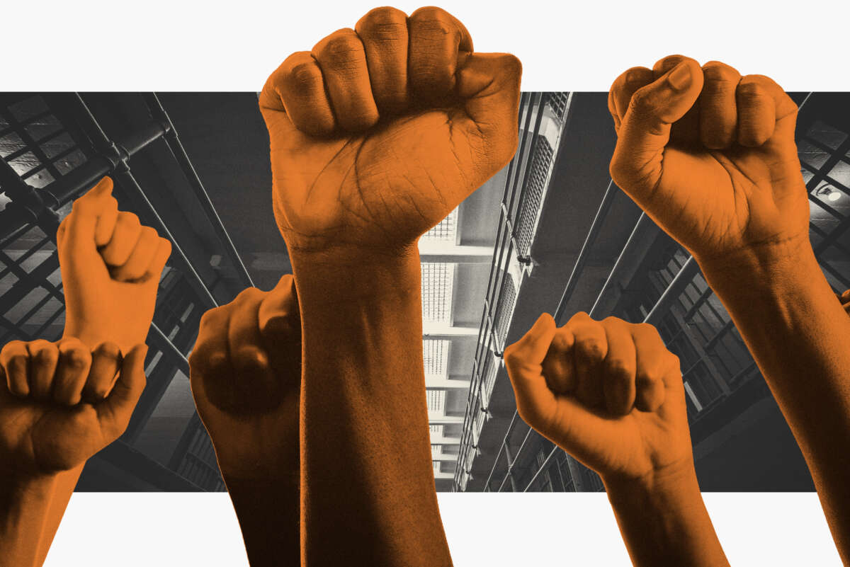 Fists are raised in the air in front of image of prison cells