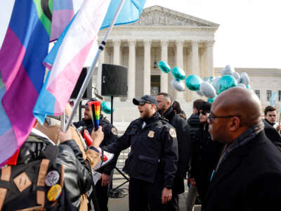 Police officers stand between LGBTQ rights supporters and supporters of web designer Lorie Smith in front of the U.S. Supreme Court Building on December 5, 2022, in Washington, D.C.