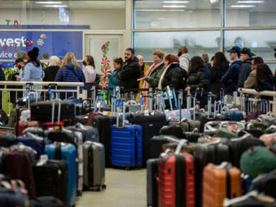 Travelers search for their luggage at the Southwest Airlines Baggage Claim at Midway Airport on December 27, 2022, in Chicago, Illinois.