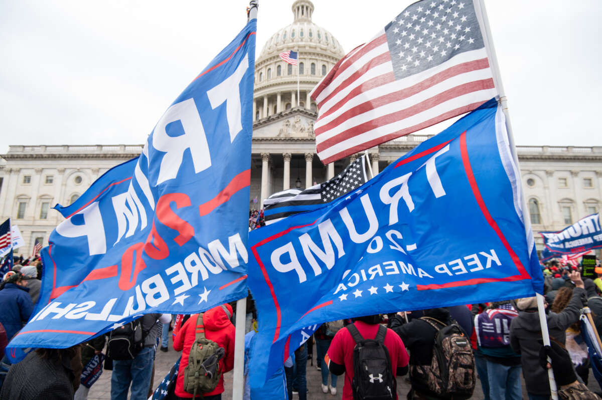 Trump flags fly as rioters take over the steps of the Capitol on the East Front on January 6, 2021, as the Congress works to certify the electoral college votes.