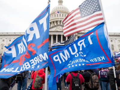 Trump flags fly as rioters take over the steps of the Capitol on the East Front on January 6, 2021, as the Congress works to certify the electoral college votes.