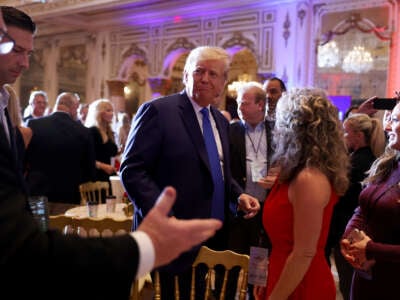 Former President Donald Trump mingles with supporters during an election night event at Mar-a-Lago on November 8, 2022, in Palm Beach, Florida.