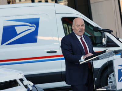 Louis DeJoy, the U.S. Postmaster General, delivers remarks announcing the Postal Service's plan on implementing electric vehicles, at the Postal Service Headquarters on December 20, 2022, in Washington, D.C.