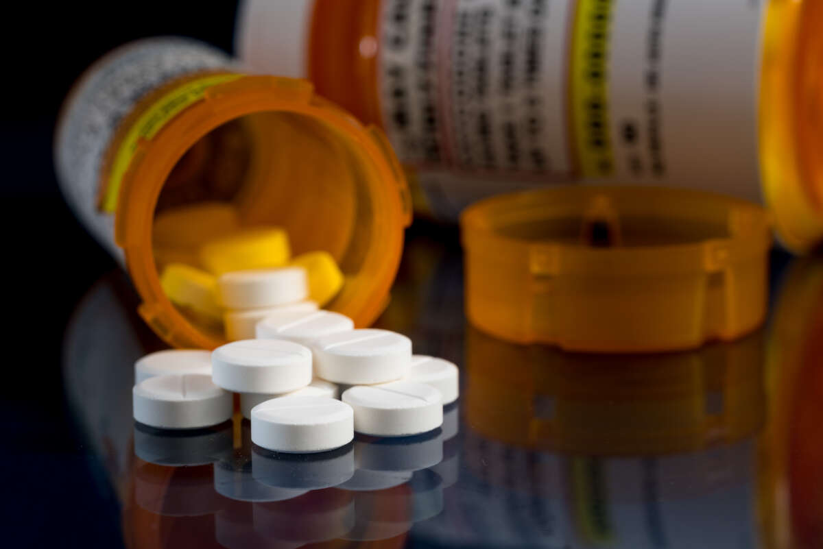 Pill bottles with pills scattered on a table