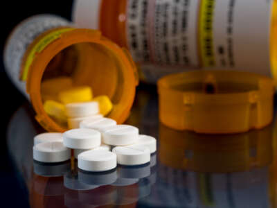 Pill bottles with pills scattered on a table