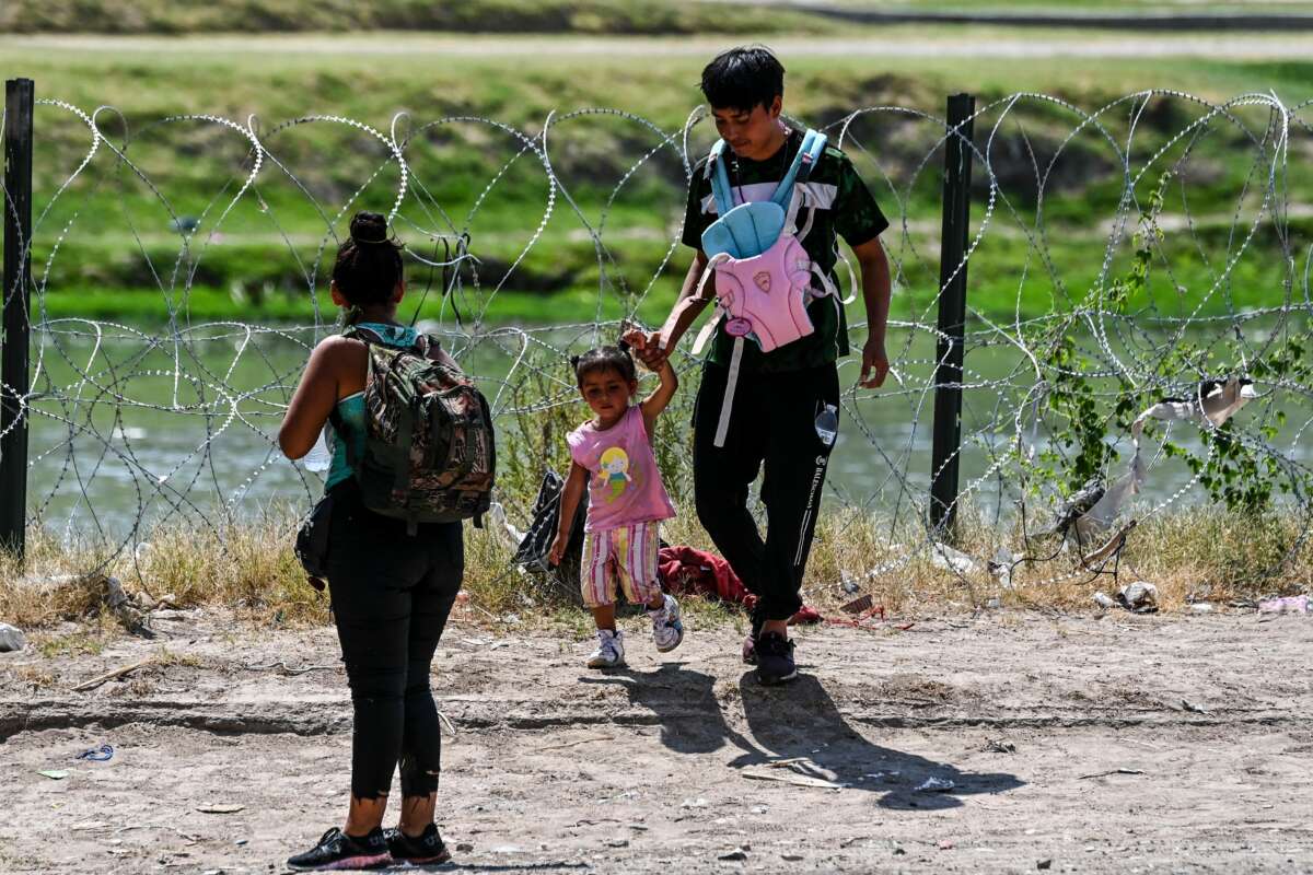 A family crosses the U.S.-Mexico border