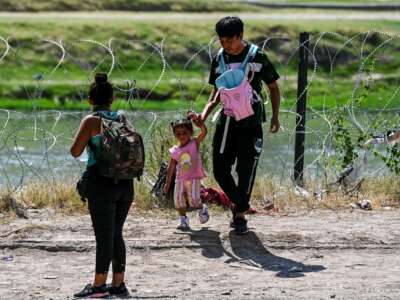 A family crosses the U.S.-Mexico border