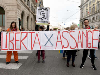 People with a banner calling for freedom for Julian Assange participate in the national demonstration against the war in Ukraine and all wars on November 5, 2022 in Rome, Italy.