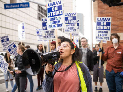 Gloria Bartolo leads marching UCLA academic workers represented by UAW as they demand better wages, student housing, child care and more on Thursday, December 1, 2022 as contract negotiations continue in Los Angeles, California.