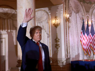 Former U.S. President Donald Trump waves after officially launching his 2024 presidential campaign at his Mar-a-Lago home on November 15, 2022 in Palm Beach, Florida.