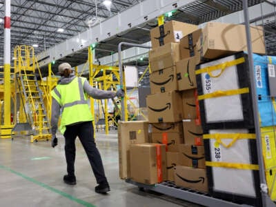 Amazon worker moving packages in a warehouse