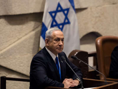Benjamin Netanyahu stands at a podium