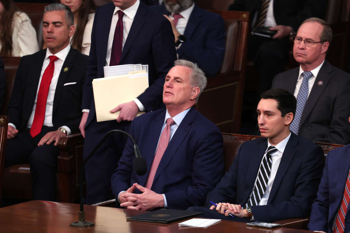 House Minority Leader Kevin McCarthy, center, takes his seat as he arrives for the start of the 118th Congress in the House Chamber of the U.S. Capitol Building on January 3, 2023, in Washington, D.C.