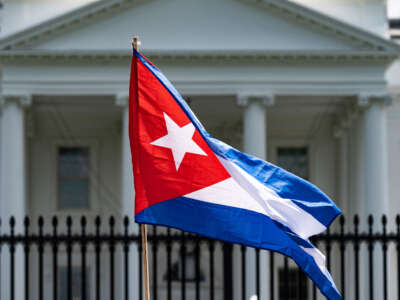 A demonstrator holds up the Cuban flag while protesting in front of the White House in Washington, D.C., on July 12, 2021.
