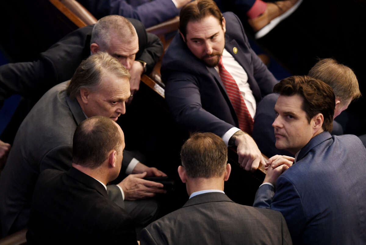 Rep. Matt Gaetz, right, looks up as Rep. Andy Biggs, left, speaks to fellow members of the House of Representatives, as voting continues for new a speaker, at the U.S. Capitol in Washington, D.C., on January 4, 2023.