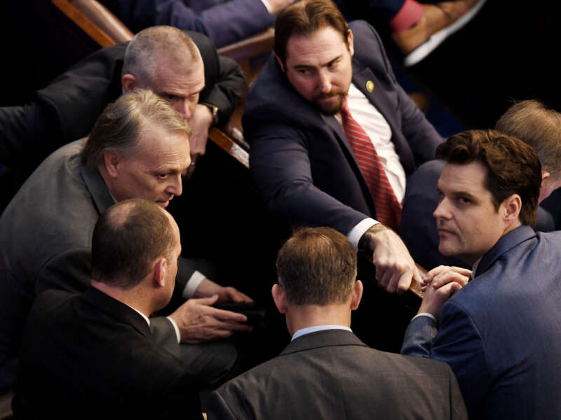Rep. Matt Gaetz, right, looks up as Rep. Andy Biggs, left, speaks to fellow members of the House of Representatives, as voting continues for new a speaker, at the U.S. Capitol in Washington, D.C., on January 4, 2023.