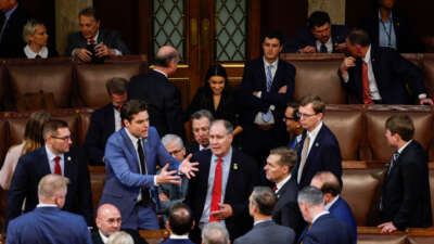 Rep.-elect Alexandria Ocasio-Cortez looks on as Republican House members-elects speak to one another during the second day of elections for Speaker of the House at the U.S. Capitol Building on January 4, 2023, in Washington, D.C.