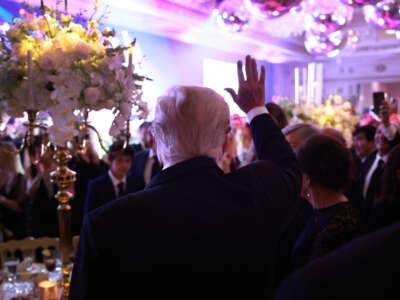 Former President Donald Trump waves as he greets people during a New Years event at his Mar-a-Lago home on December 31, 2022, in Palm Beach, Florida.