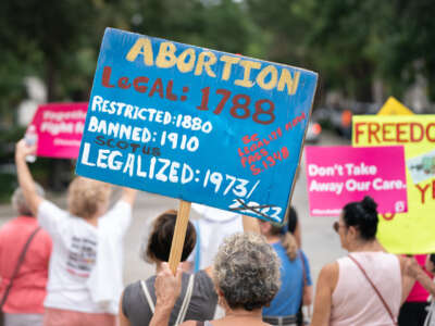 Demonstrators hold signs in front of the South Carolina Statehouse as lawmakers debate an abortion ban in Columbia, South Carolina, on August 30, 2022.