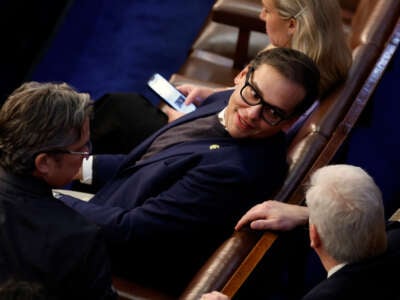 Rep.-elect George Santos, center, talks to Rep.-elect Tom Emmer, right, and Rep.-elect Andy Ogles in the House Chamber during the third day of elections for Speaker of the House at the U.S. Capitol Building on January 5, 2023, in Washington, D.C.