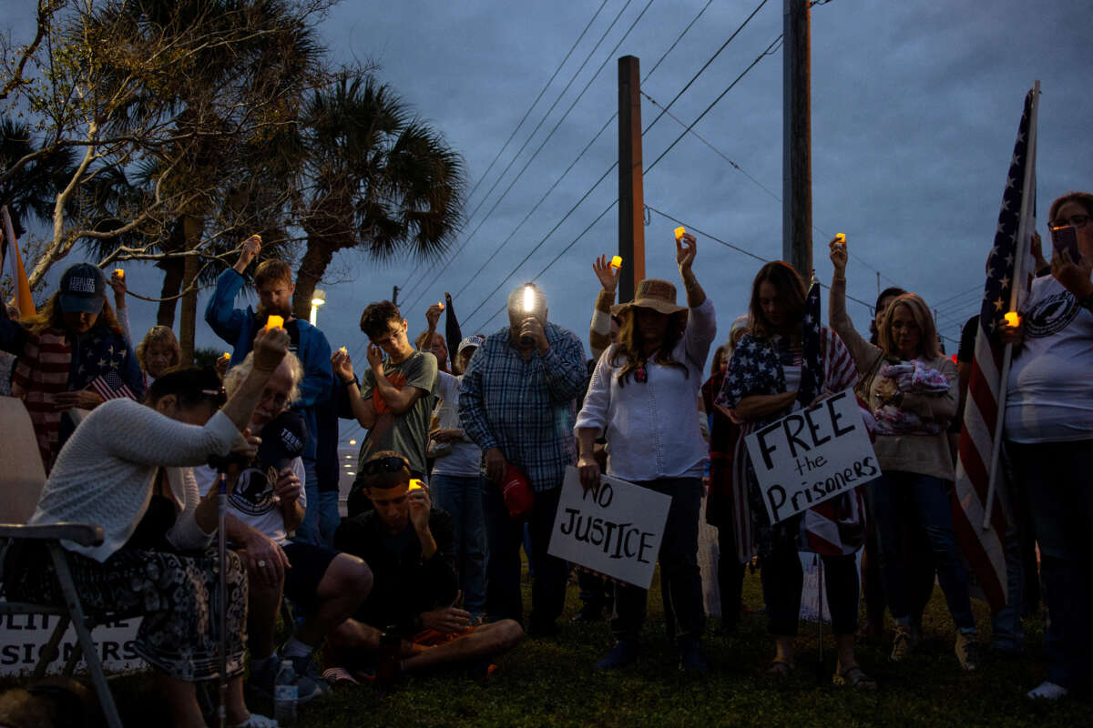 Supporters of former President Donald Trump gather to hold a protest rally and candlelight vigil in support of people arrested for their activities attacking the U.S. Capital exactly one year earlier, January 6, 2022, outside of the Pinellas County Jail in Clearwater, Florida.