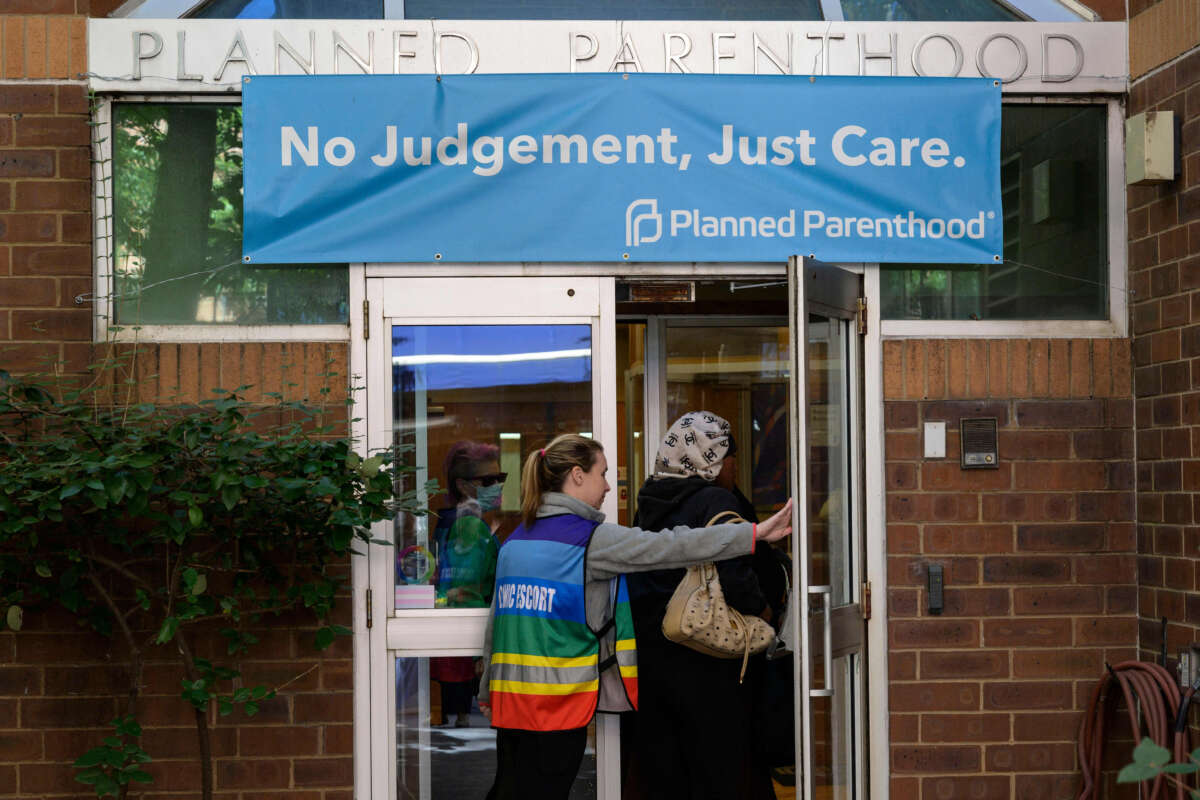 A clinic escort assists a patient at a Planned Parenthood Health Center in Philadelphia, Pennsylvania, on September 28, 2022.