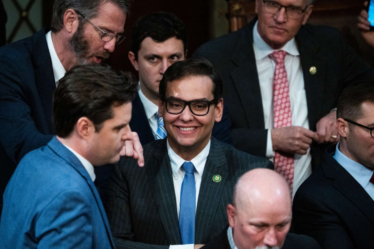 Rep.-elect George Santos, center, is seen on the House floor after a vote for House speaker on January 4, 2023.