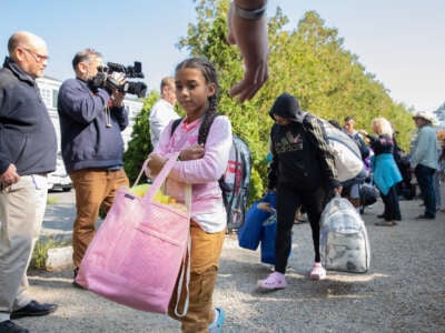 Undocumented immigrants are loaded onto a bus to be transported off Marthas Vineyard in Edgartown, Massachusetts, on September 16, 2022.