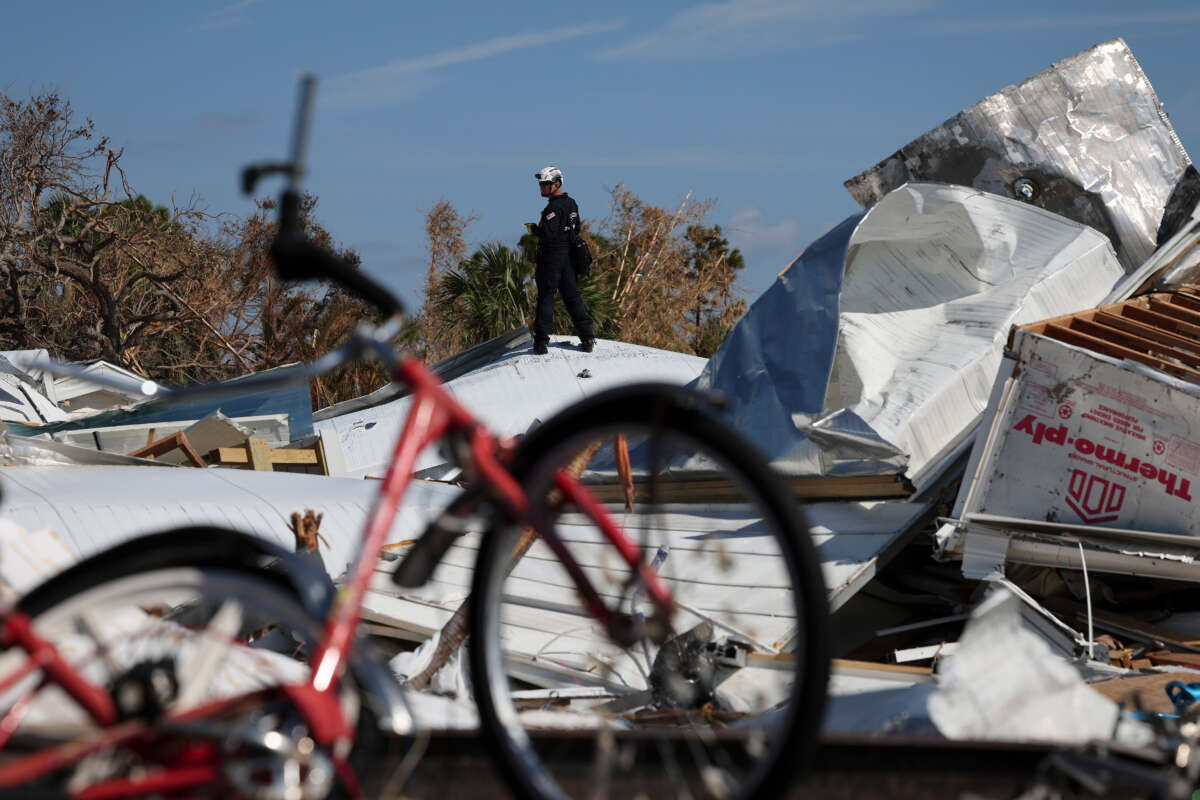 Members of the Virginia Task Force 2 Urban Search and Rescue team comb through the wreckage on Fort Myers Beach looking for victims of Hurricane Ian October 4, 2022, in Fort Myers Beach, Florida.