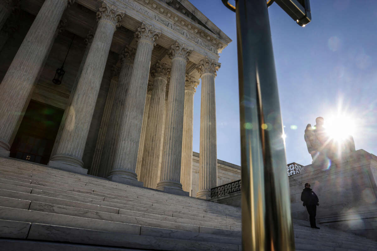 A U.S. Supreme Court police officer stands guard on the steps of the court in Washington, D.C. on December 28, 2022.