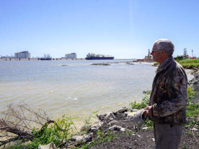 66-year-old retiree John Allaire stands in front of the Seapeak Magellan liquefied natural gas (LNG) tanker and Venture Global Calcasieu Pass LNG export terminal in Cameron, Louisiana, on September 29, 2022.