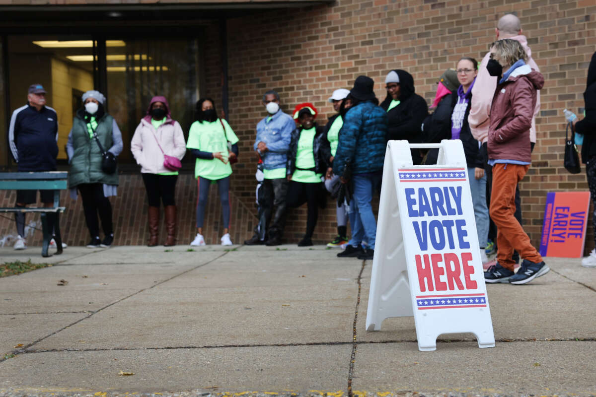 People wait in line outside a polling place at the start of early voting on October 25, 2022, in Milwaukee, Wisconsin.