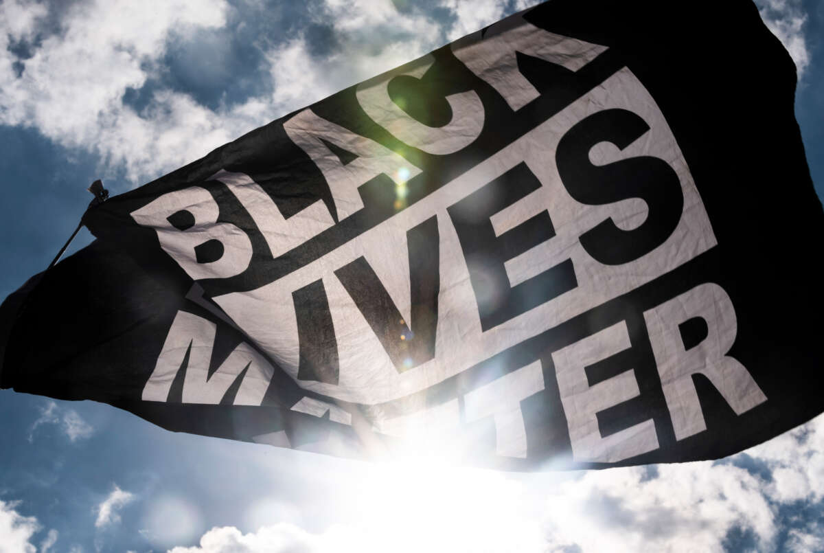 A Black Lives Matter flag waves during a demonstration outside the First Police Precinct Station on June 13, 2020, in Minneapolis, Minnesota.