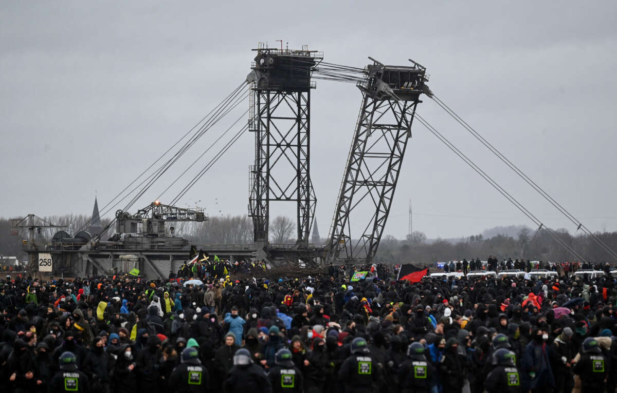 Police face protesters during a large-scale protest to stop the demolition of the village Luetzerath to make way for an open-air coal mine extension on January 14, 2023.