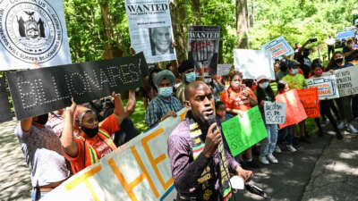 Jamell Henderson, a protest organizer, speaks outside of Michael Bloomberg's Southampton home demanding higher taxation of billionaires on July 1, 2020.