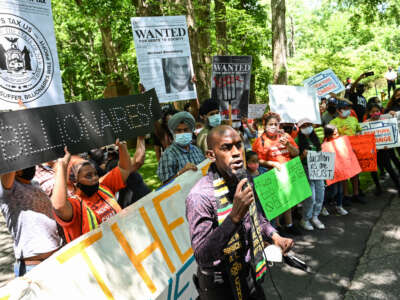 Jamell Henderson, a protest organizer, speaks outside of Michael Bloomberg's Southampton home demanding higher taxation of billionaires on July 1, 2020.