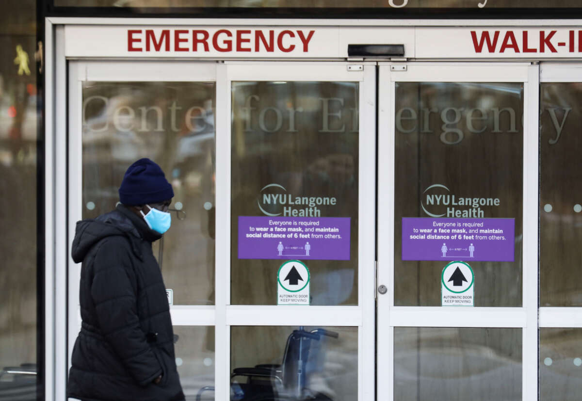 A pedestrian walks past the entrance of an emergency room of a hospital in New York on December 13, 2021.