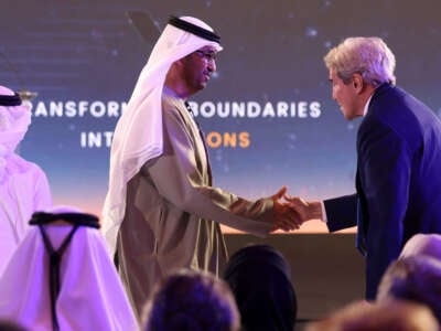 United Arab Emirates' Minister of State and CEO of the Abu Dhabi National Oil Company Sultan Ahmed al-Jaber, left, welcomes U.S. Presidential Envoy for Climate John Kerry at the opening session of the Atlantic Council Global Energy Forum, in Abu Dhabi, on January 14, 2023.