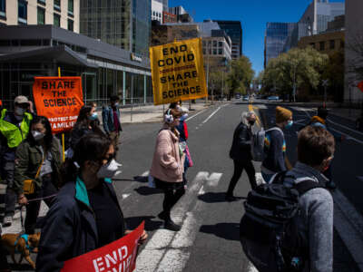 Dozens of demonstrators rally in front of Moderna's headquarters during its annual shareholder meeting in Cambridge, Massachusetts, on April 30, 2022.