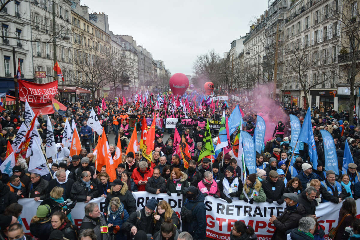 Demonstrators march as they hold various banners in Paris, France, on January 19, 2023. Workers, employees and students hold a strike against the French president's plan to raise the legal retirement age from 62 to 64.