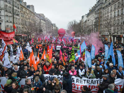 Demonstrators march as they hold various banners in Paris, France, on January 19, 2023. Workers, employees and students hold a strike against the French president's plan to raise the legal retirement age from 62 to 64.
