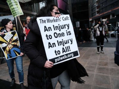 Members of the Amazon Labor Union and others protest outside of the New York Times DealBook Summit on November 30, 2022, in New York City.