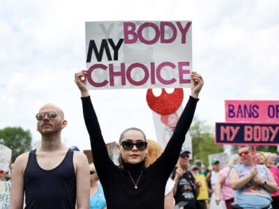 A protester holds a sign reading "MY BODY MY CHOICE" during an outdoor protest