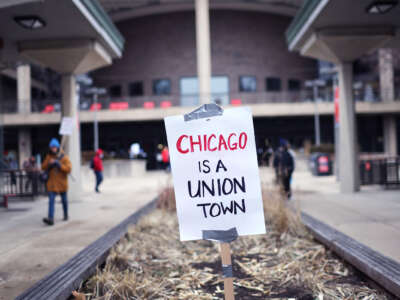 A sign reading "CHICAGO IS A UNION TOWN" stands in an otherwise empty planter
